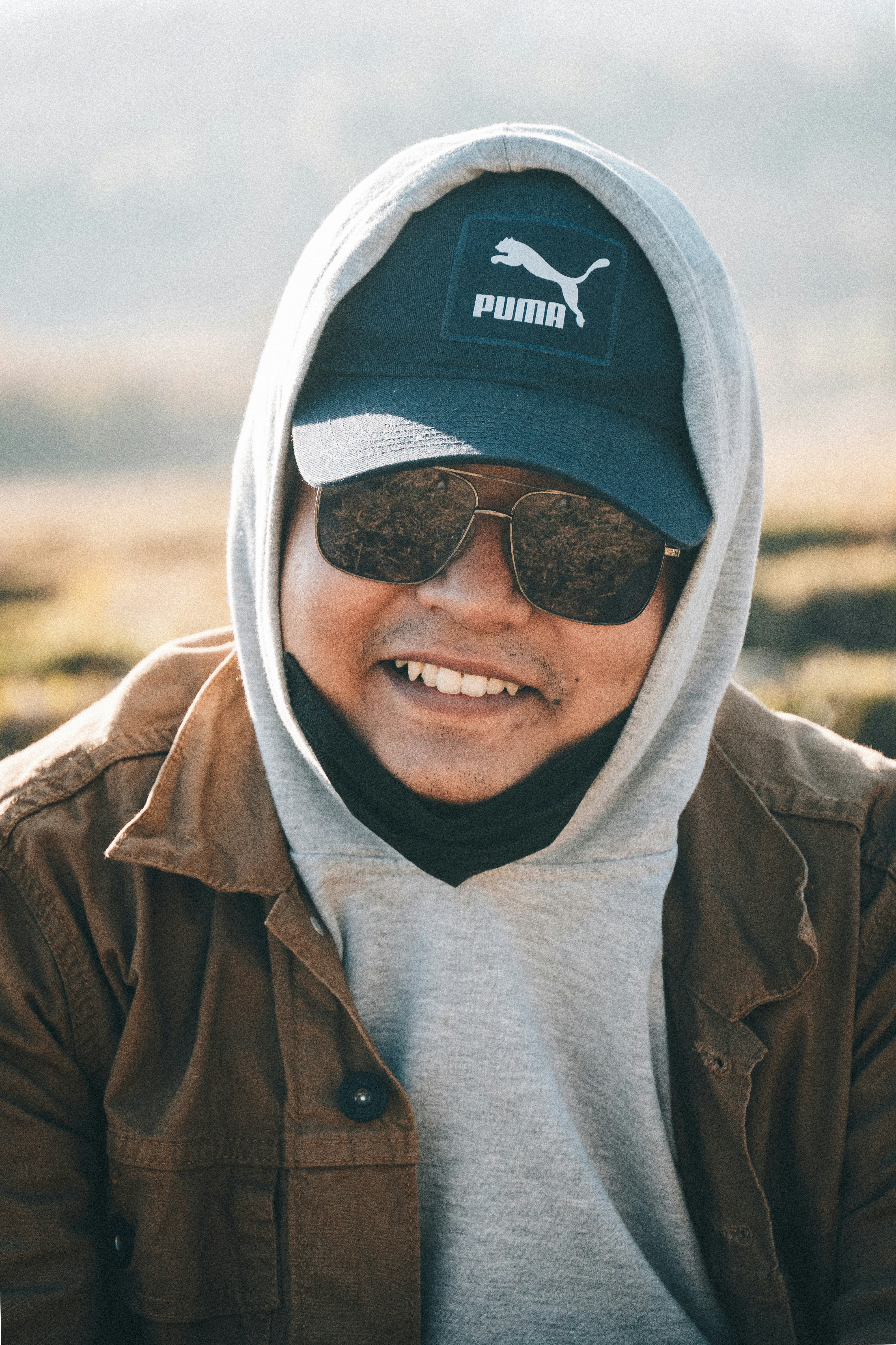 a man wearing a hat and sunglasses